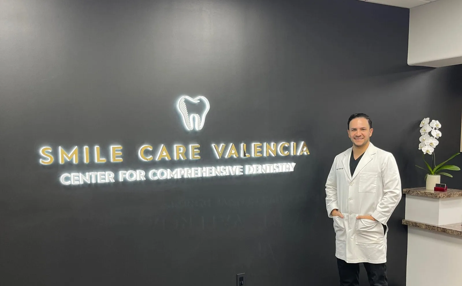 Dentist standing in front of Smile Care Valencia.