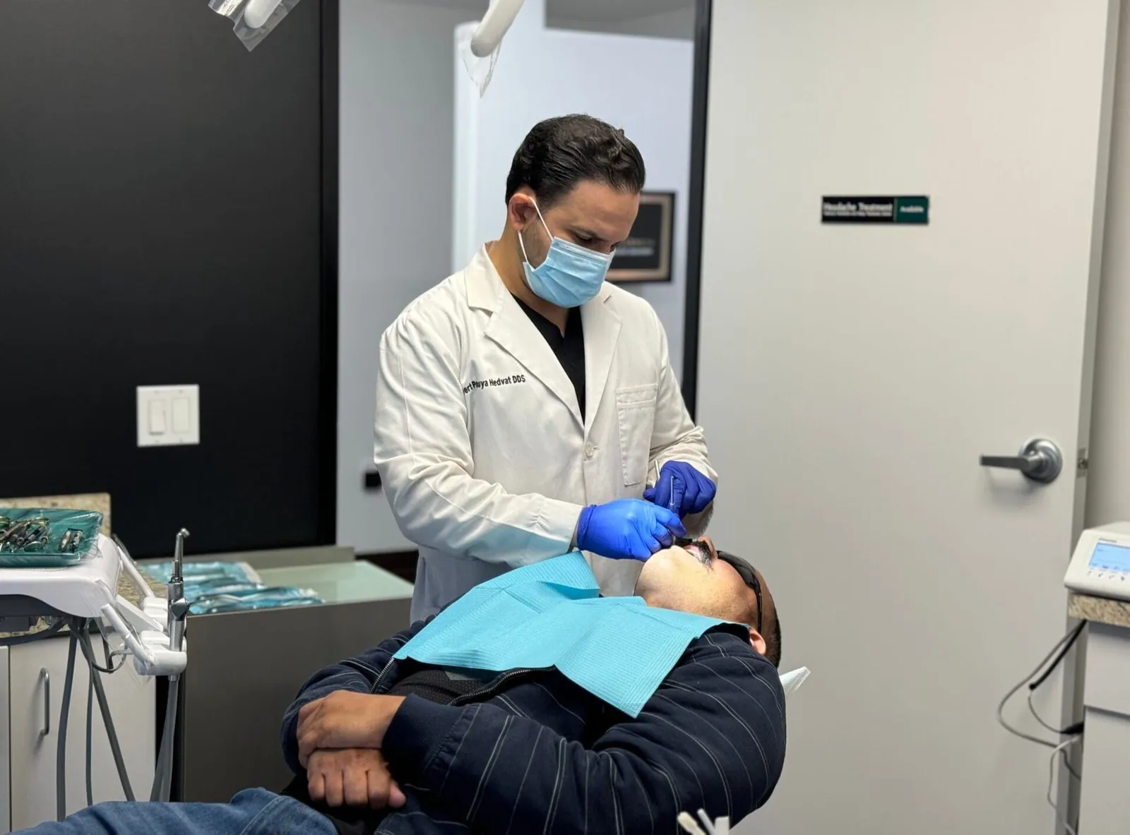Dentist smiling confidently wearing their uniforms in a clinic.