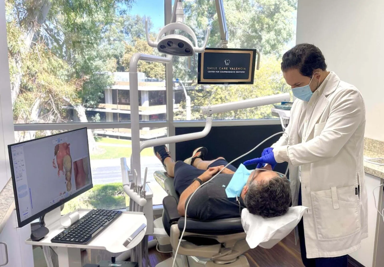 Dentist examining patient in dental chair.