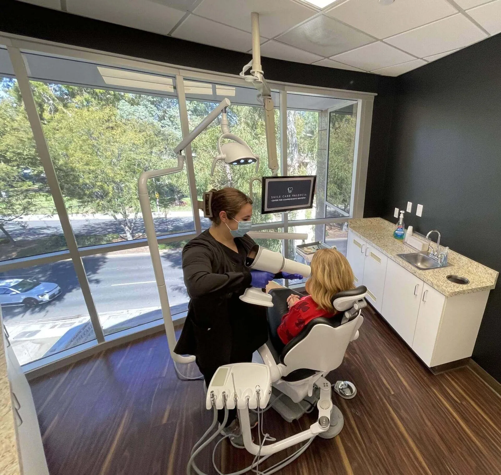 Dentist examining patient in a dental chair.