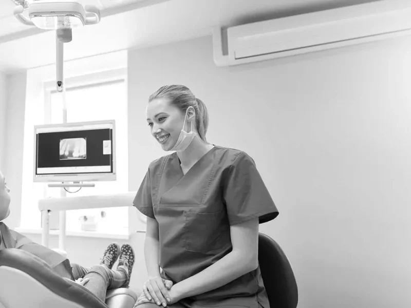 Dentist smiling confidently wearing their uniforms in a clinic.